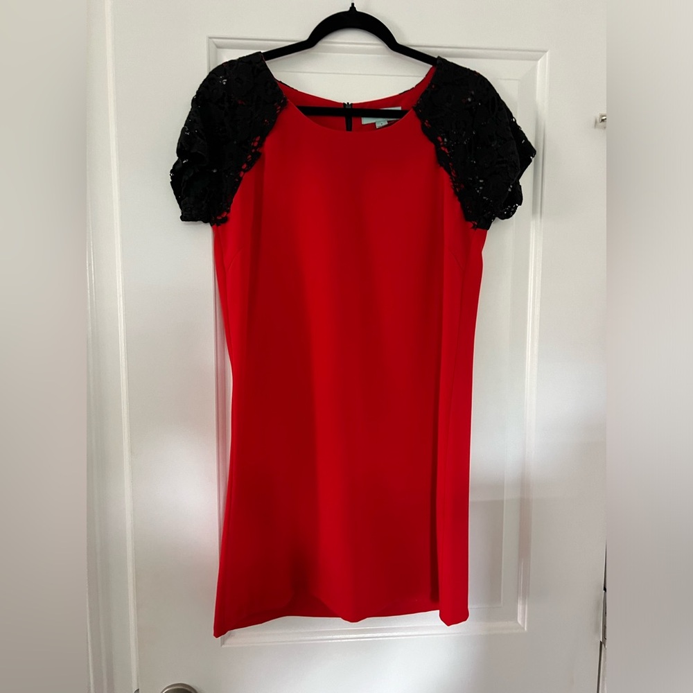Francesca’s size M. Red dress with black lace sleeves. NWOT.